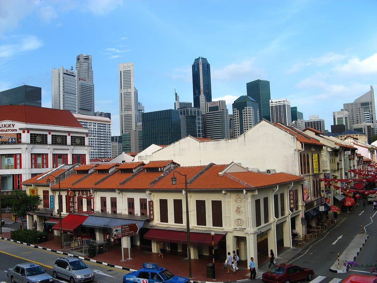 Restored shophouses at the junction of New Bridge Road and Smith Street in Singapore, with the city towers behind