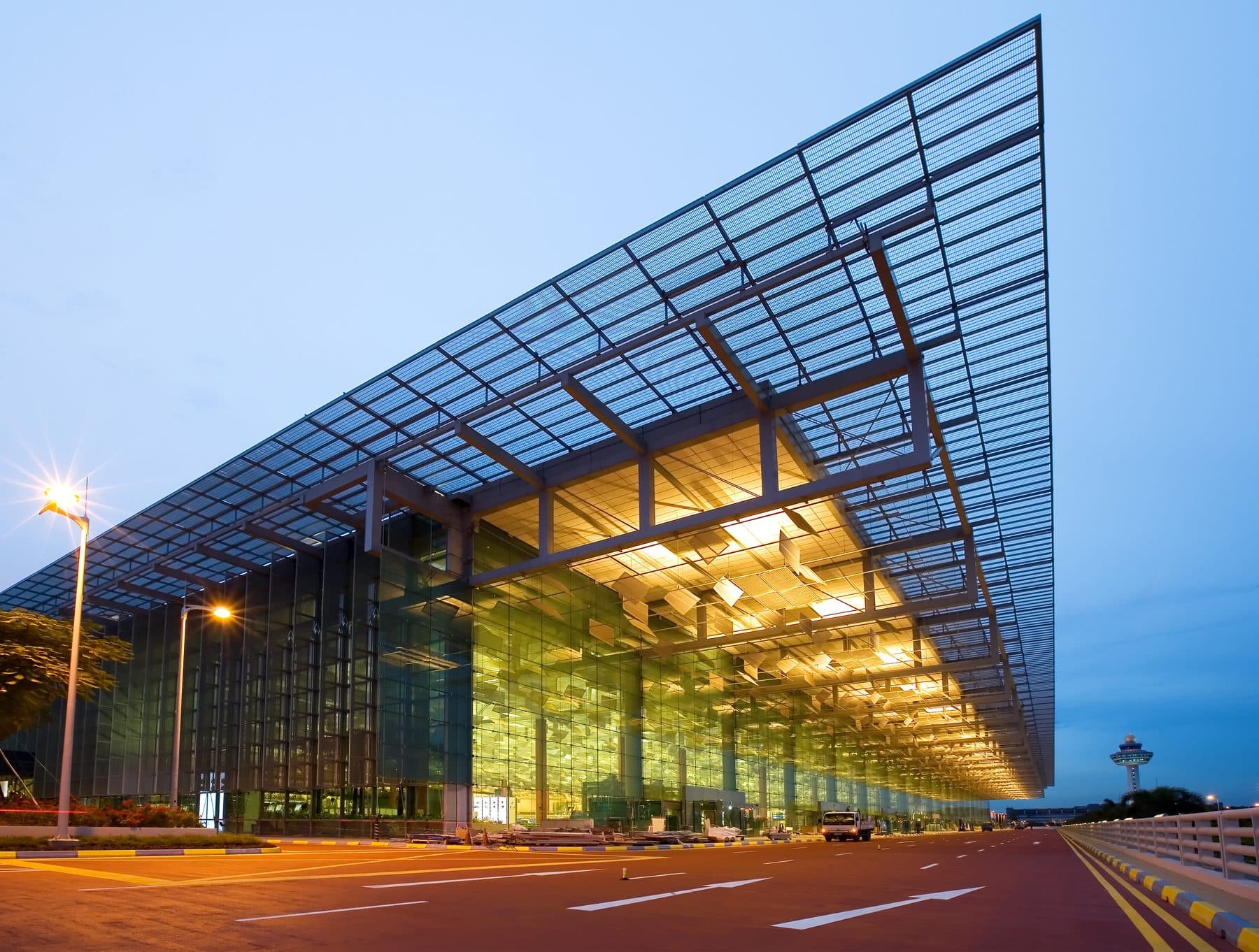 The departure kerbside canopy of Changi Airport Terminal 3 in Singapore, lit at dusk